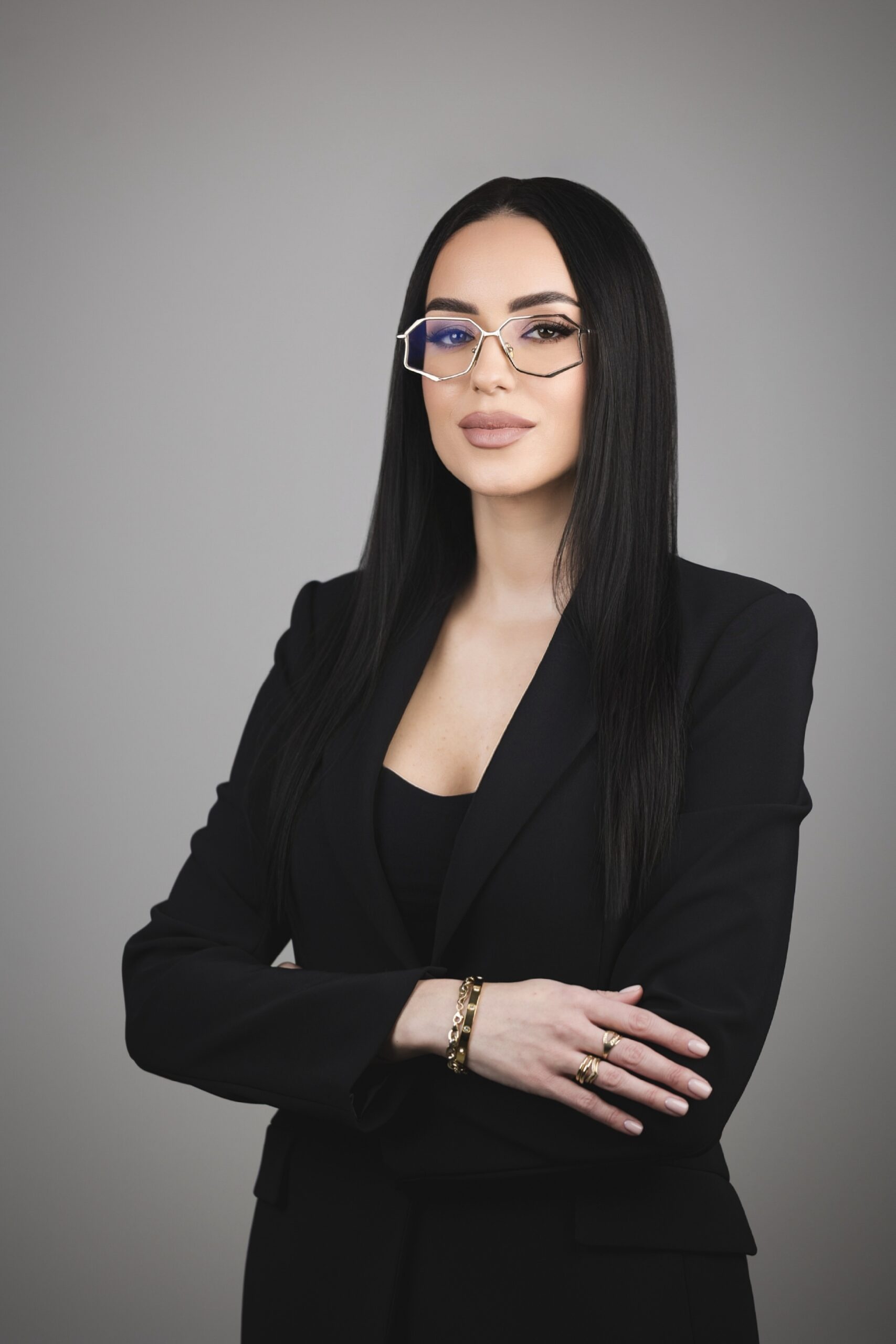 andrea-adzic-2 Andrea in formal attire seated elegantly.